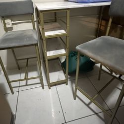 Plastic Server Table With Two Gray Chairs 