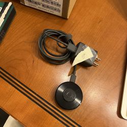 Google Chromecast streaming media player, specifically one of the earlier generations (likely 2nd or 3rd generation