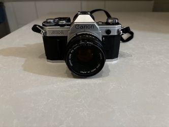 Canon AE-1 35mm film Camera  with Canon  lens FD   50mm 1:1.8 sc lens , tested in perfect condition .