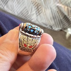 A Designer Unique Ring With Rotating Blue Enameled Charm