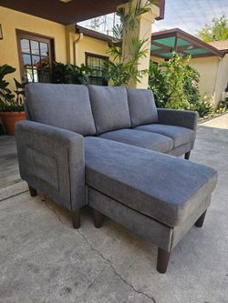 Compact Dark Gray Sofa with Reversible Chaise