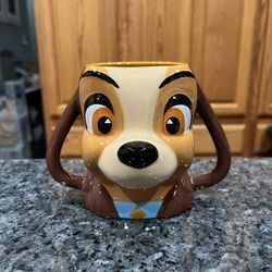 Disney Parks Lady and The Tramp “Lady” Sculptured Coffee Mug.  Size approximately  4 3/4 inches tall.  Perfect condition the lighting is bad there are