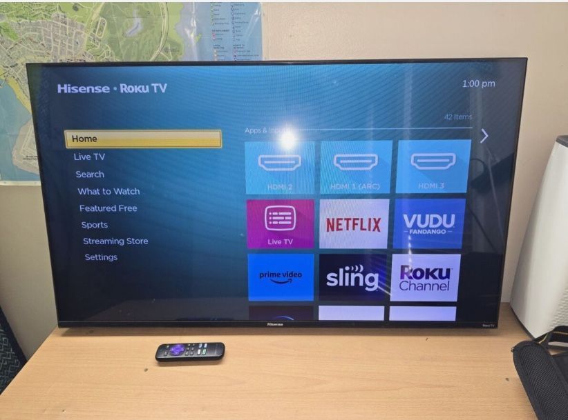 Hisense Roku Smart TV with remote and power cable included.