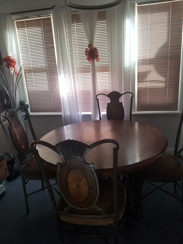 Solid Wood and metal table with 4 chairs.