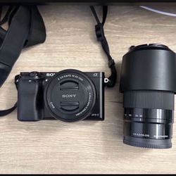 Sony Alpha a6000 Mirrorless Digital Camera w/ 16-50mm and 55-210mm Power Zoom Lenses. And 3 Batteries And Charger 