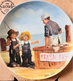 This decorative Knowles porcelain plate from 1983 features the "Fish Story" artwork by Jeanne Down