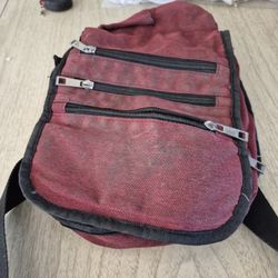 red bag with 5 zippered pockets.