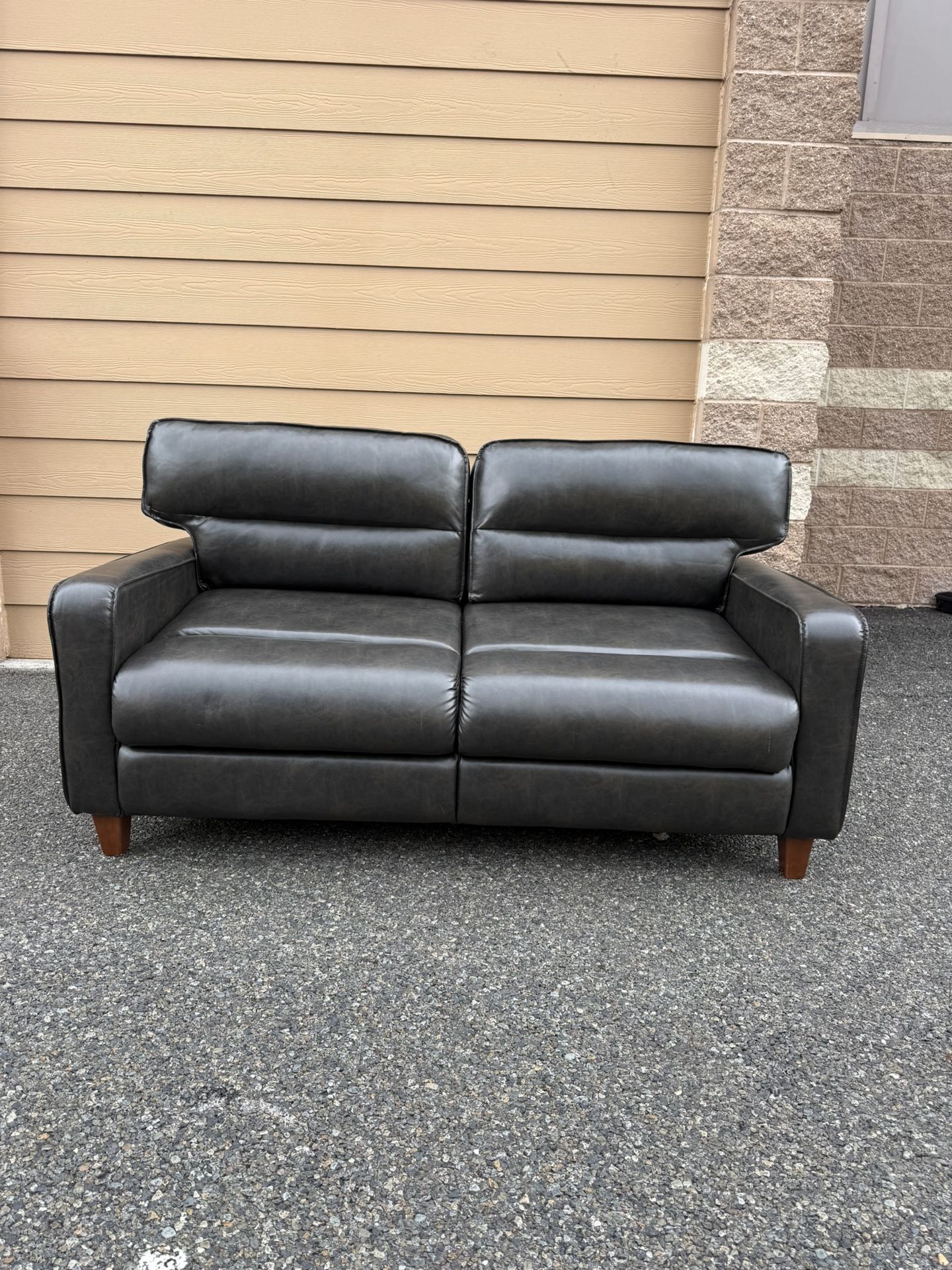Double sofa. Leather sofa in chocolate color. Sofa bed