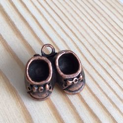 Antique copper baby shoe pin/pendant