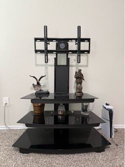 Glass, metal and wood entertainment center with tv mount.