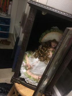 Porcelain doll in glass