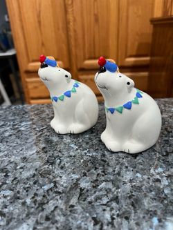 Vintage ceramic Polar Bear with a Fish Salt and Pepper Shakers.  Size  approximately 4 inches tall.  Brand new never used.  Has been on display in a c