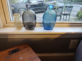 Blue And Purple Lestoil Bottles, And One Milk Bottle
