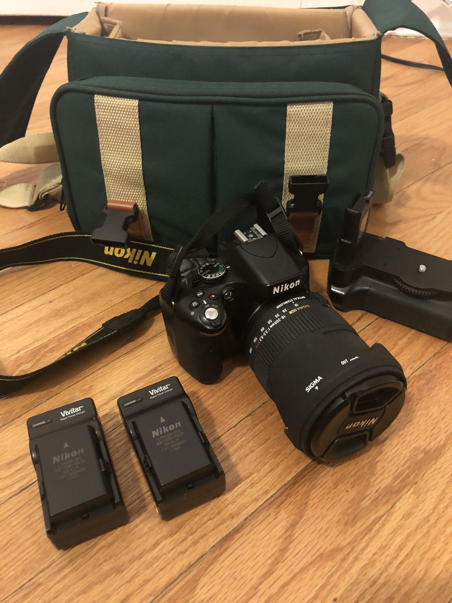 Nikon D5100 with Canon Carrying case , 2 batteries with chargers, extended battery holder , and Sigma Dc 18-200mm Lens
