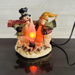 Crazy Mountain Company Flickering Light up Christmas snowmen/ campfire light decor. 5” tall x 6 1/2” wide.  Works great . Has toggle Off and on switch