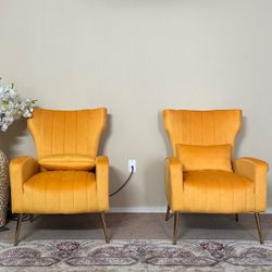 Two velvet yellow accent chairs