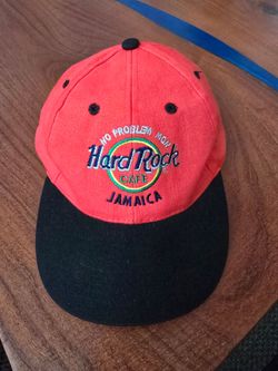 The Vintage 90's Hard Rock Cafe Jamaica Adjustable Dad Hat Cap is a retro streetwear accessory perfect for casual occasions. This navy and red snapbac