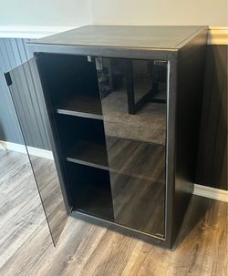 Black cabinet with glass doors.