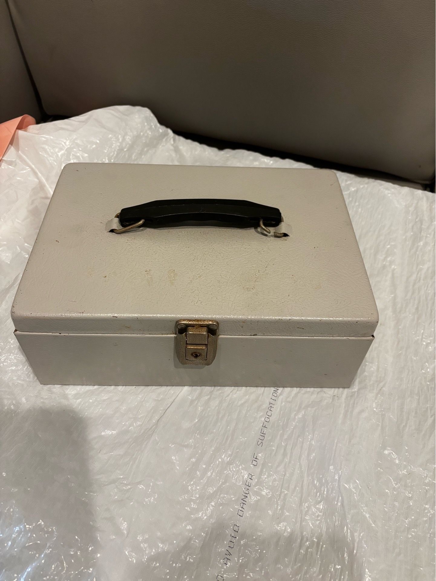 Grey metal cash box with coin tray. No key