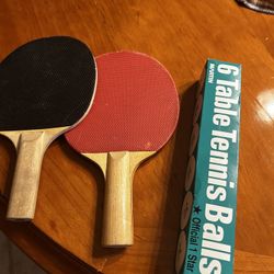 Two ping-pong paddles and balls