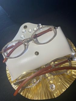 One (1) Millionaire Celebrity Italian Unisex wooden frame with sparkling lab, diamond ice trim. Comes with a white protective case for secure storage.