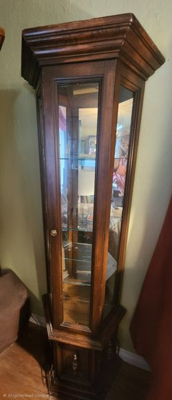 Cute Dark Wood mirrored curio with light and glass shelves. Lower cabinet
24"w x 10.5"d x 70.75"h