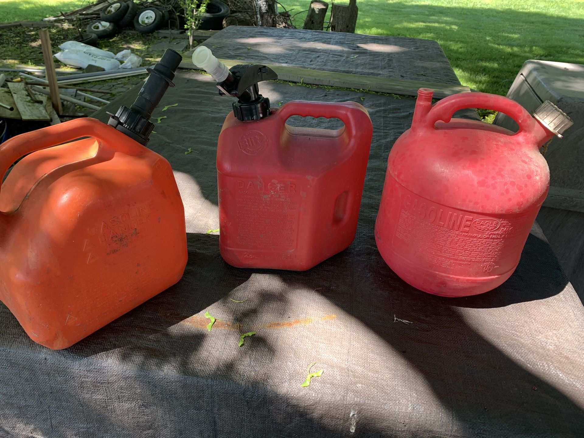 Tree gas cans, 5 gallons, 2 gallons and two and half gallon