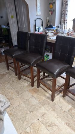 8 counter high chairs brown fox leather material  Some has button missing one chair has broken back piece as seen in last picture and little ripped on