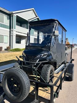 Covered golf cart with trailer