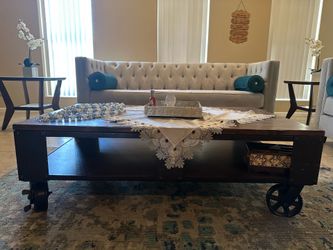 Industrial Rustic Wood Coffee Table with Metal Wheels from Wayfair