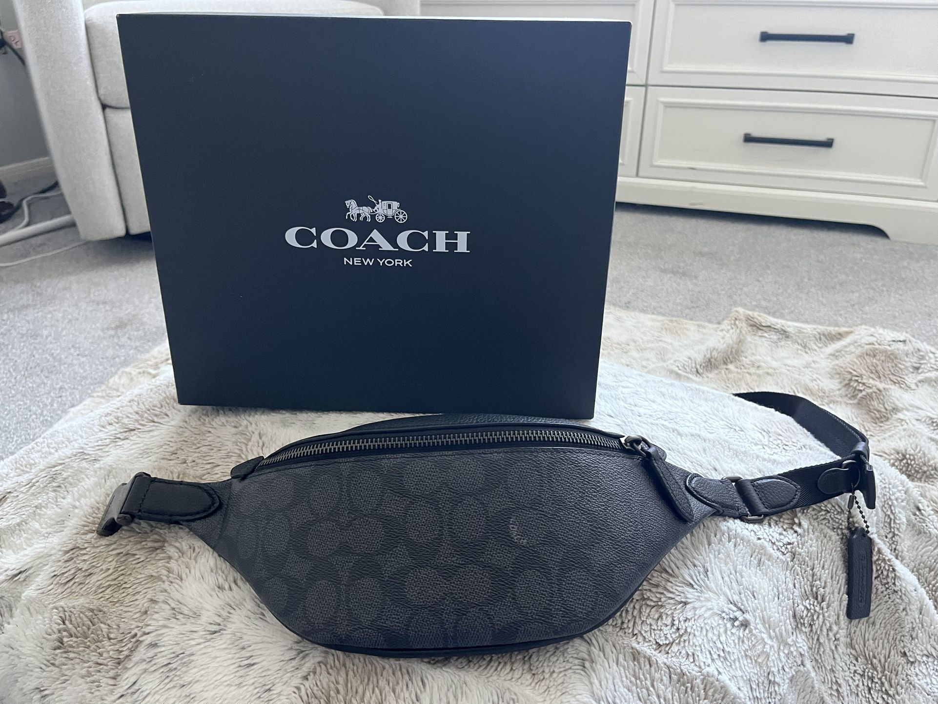 Coach Charter Belt Bag 7 in black with signature Coach logo.