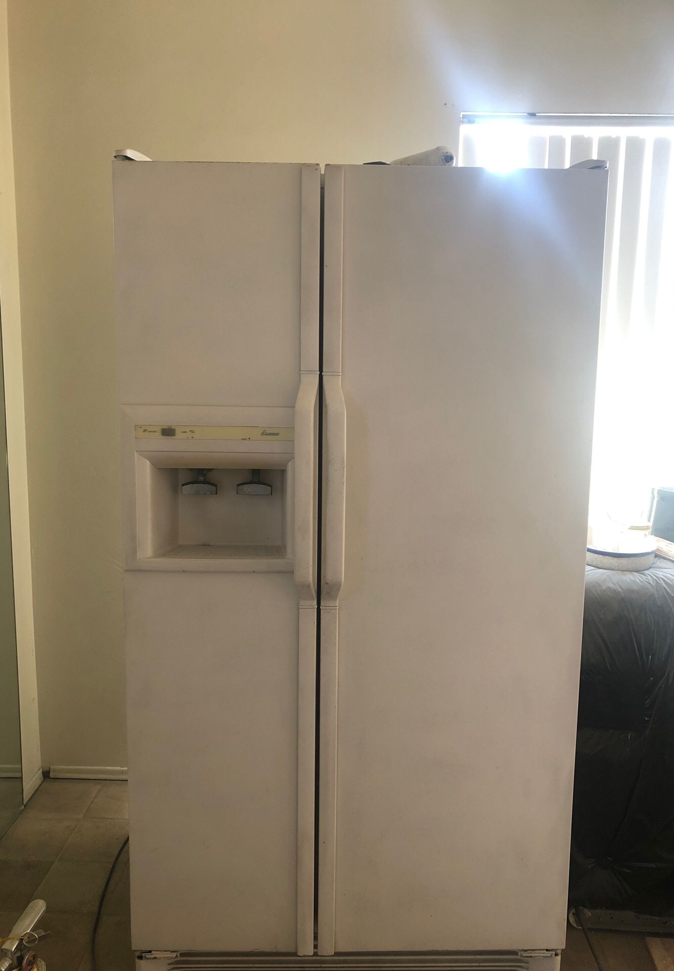 Fridge in working condition with ice and water