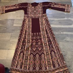 Elegant traditional embroidered Palestinian dress in burgundy color