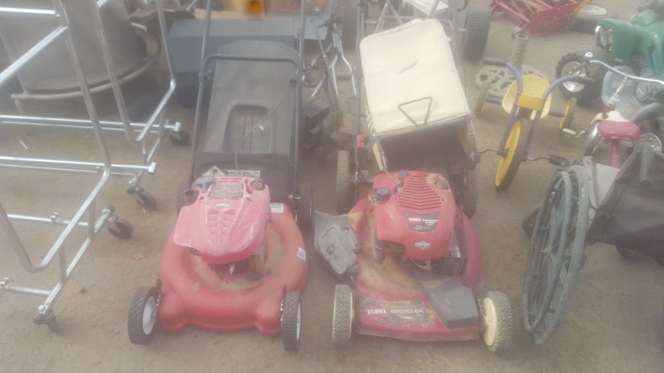2 lawn mowers with bag catchers