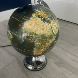 Troika Terra Light Globe, which features a chrome base and illuminated physical map. Sells for $190 retail .. asking $45