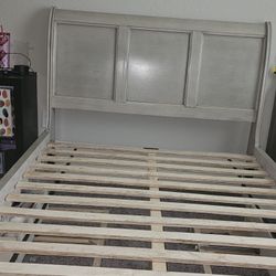 full-size bed frame with a twin-size trundle and matching dresser set with mirror