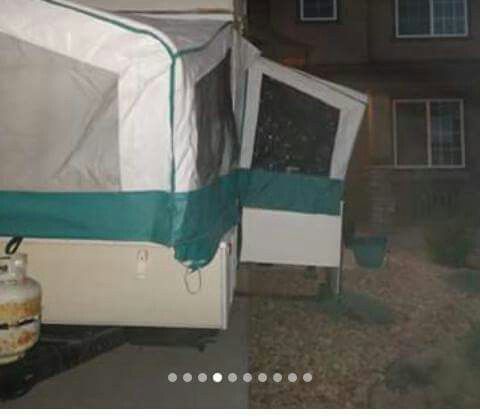 Pop up camper with slide out table/bed