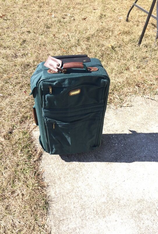 Green jaguar suit case on wheels 15 by 23 with key and lock