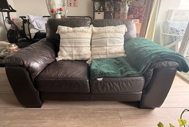 Dark brown leather sofa and armchair.