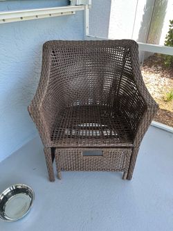 Outdoor chair with foot rest and cushions and table