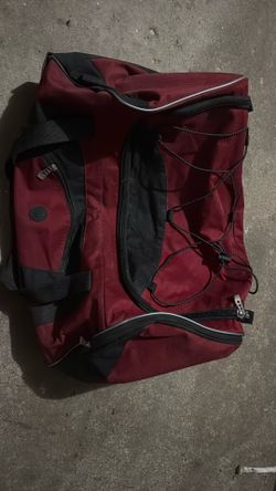 Protege 25 in Rolling Duffel Bag for Travel, Red