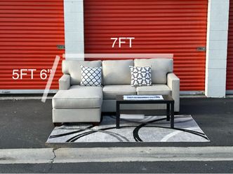 Beige sectional sofa with reversible chaise