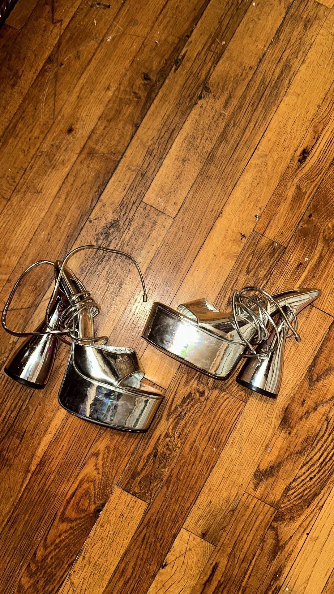 Metallic platform high heel with an ankle strap.