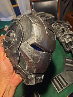 Custom made resin casted battle damaged war machine helmet display