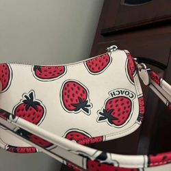 Coach Swinger 20 bag with a strawberry print