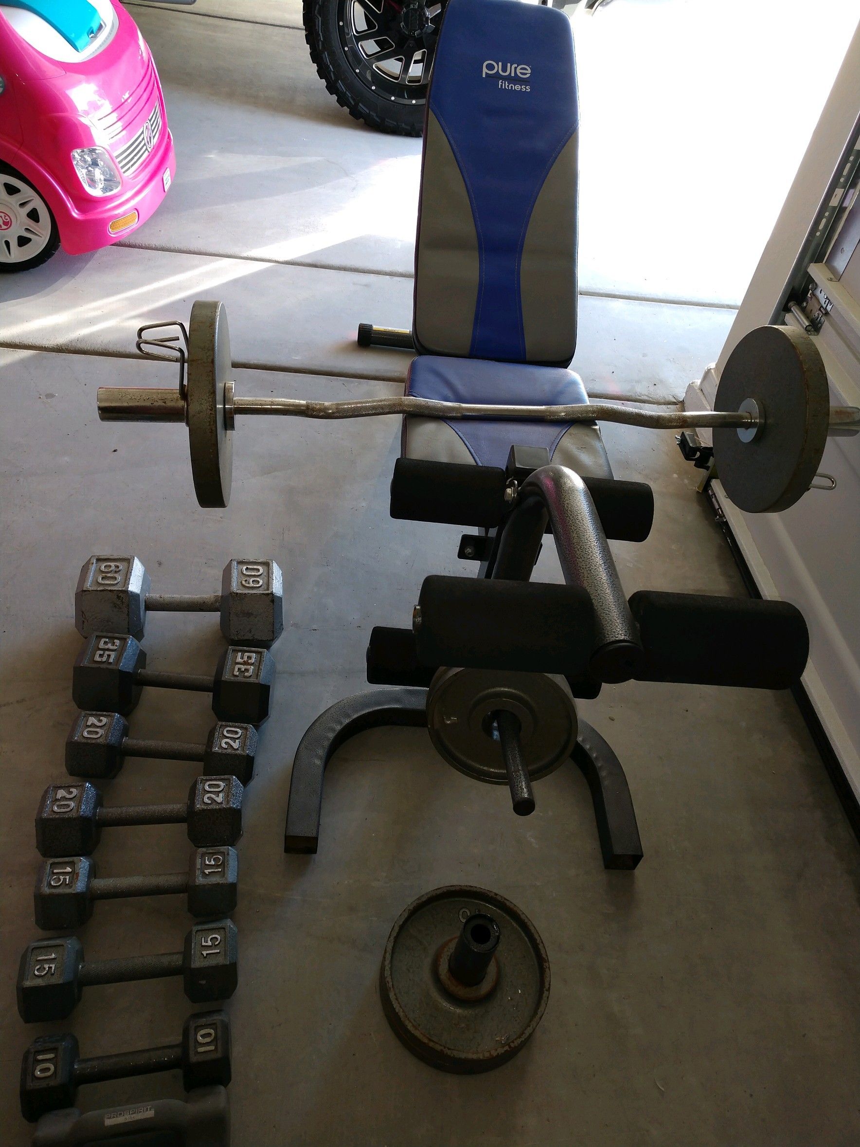 Dumbbells and bench plus curl bar with plates