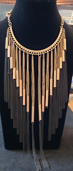 Black and gold tone chain fringe tassel cascading bib necklace. Necklaces 20-in. Tassel hangs 10 in. Tassel is 4 in wide.