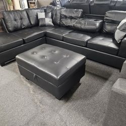 Brand New 108" x 81" Black Faux Leather Reversible Sectional With Cup Holders And Storage Ottoman