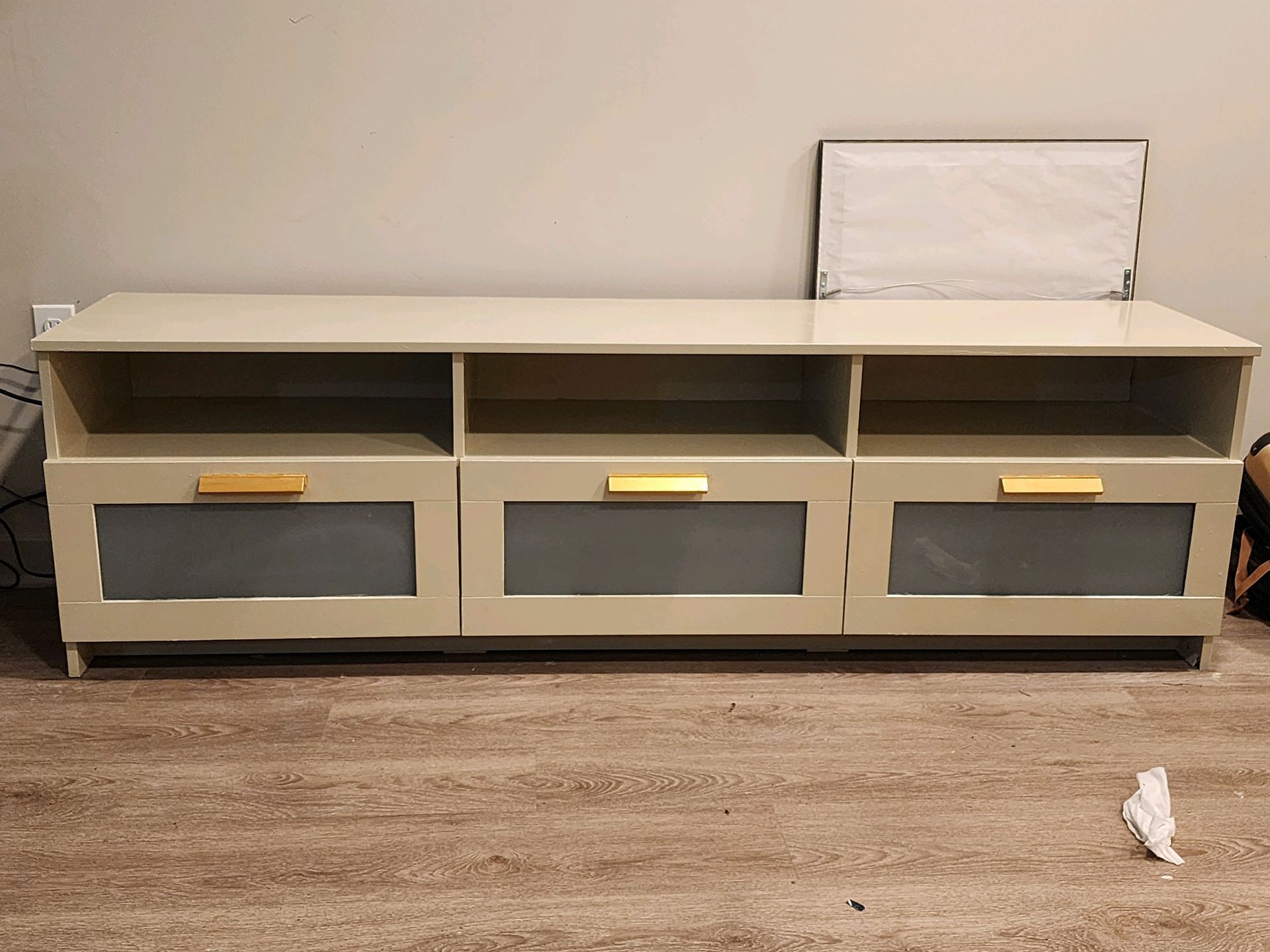 75” Almond TV Stand With Gold Hardware On Drawers. 
