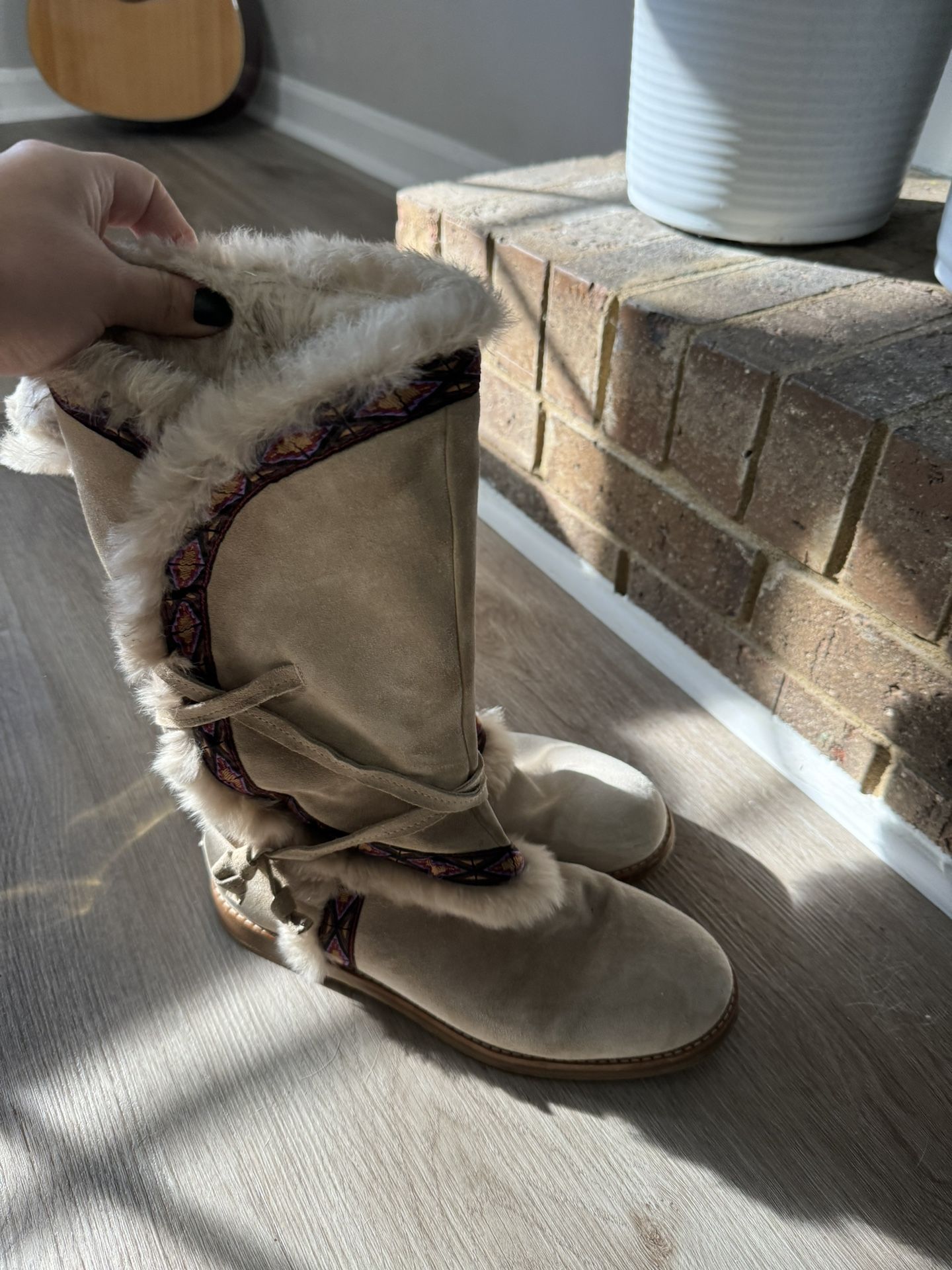 Jimmy CHOO pairs of flat Indian-inspired boots in sandy suede lined with fur.